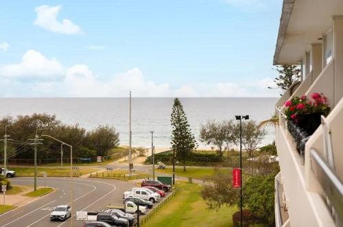 a view of a parking lot with cars on a road at Blue Palms By The Beach in Gold Coast