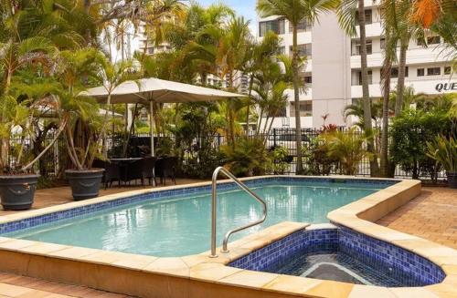 a swimming pool in the middle of a hotel at Blue Palms By The Beach in Gold Coast