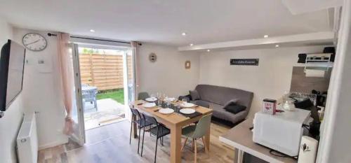 un salon avec une table et un canapé dans l'établissement Très grande maison individuelle, à Aurillac