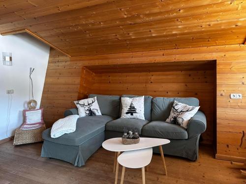 a living room with a couch and a table at Obinghof in Fieberbrunn