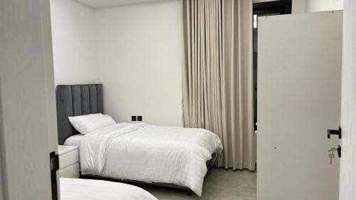 a bedroom with two beds with white sheets at شقة فاخرة ومميزة في حي الملقا - luxury premium apartment in Al Malaga in Riyadh