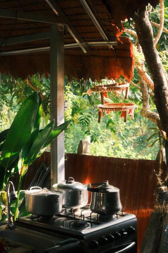 a stove with three pots on top of it at Madam Sokha Homesteading in Siem Reap