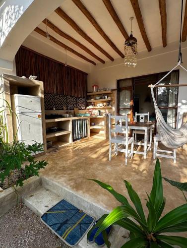 a kitchen and dining room with a hammock at Mgongo tree house in Jambiani