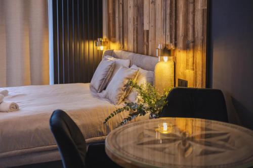 a bedroom with a bed and a table with a coffee table at Zwierzyniecka Residence in Zakopane