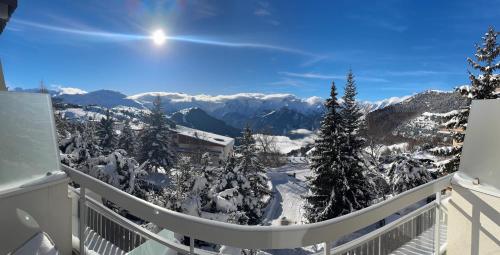 a balcony with a view of a snow covered mountain at Le Nid Lumiere in LʼHuez