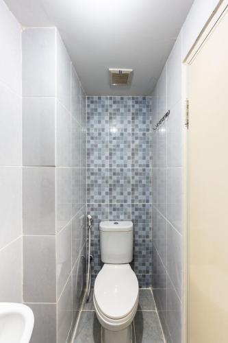 a bathroom with a toilet and a sink at Modern Living in Tokyo Riverside Apartment PIK2 in Muara