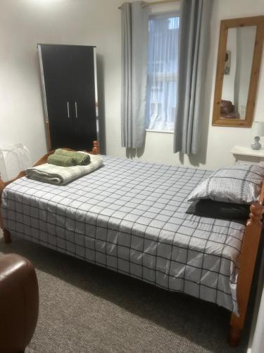 a bedroom with a bed and a mirror and a window at Spacious Property For Hols Base & Contractors Long or Short Stays C2C Western Lakes in Cleator Moor