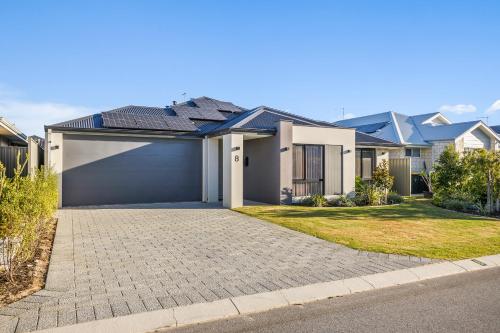 a house with a garage in a residential neighborhood at Amberton Beachs Little Paradise By Swan Bnb in Alkimos