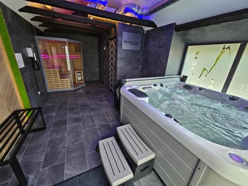 a large jacuzzi tub in the middle of a room at Richmount Apartamenty Karpacz in Karpacz