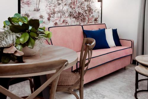 a living room with a couch and a table at Hotel Aptos Alejandra Home by Maxi Hoteles in Granada