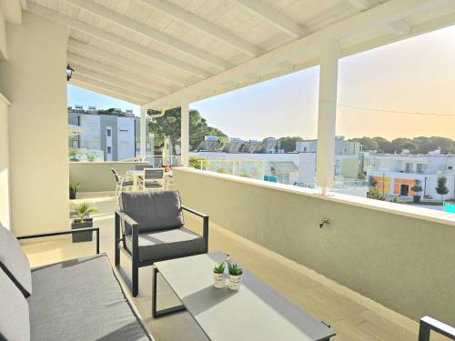 a balcony with a chair and a table at Sunny Beach Penthouse - 216 in Durrës