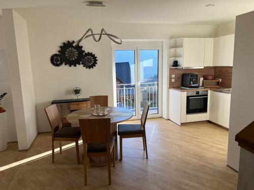a kitchen and dining room with a table and chairs at Ferienhaus Wildblick in Schwanberg