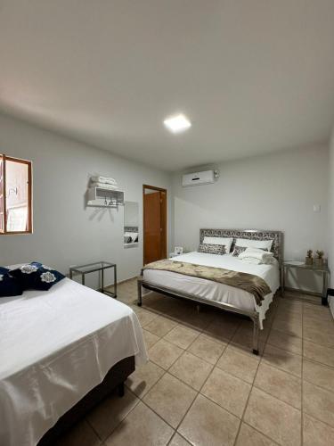 a bedroom with two beds in a room at Pousada Água Doce - Porto Eucalipto in Pôrto São José