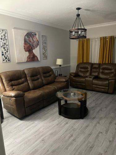 a living room with a couch and a table at Rafeal in Houston