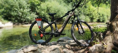 a bike parked on some rocks next to a river at L'Interlude in Mons