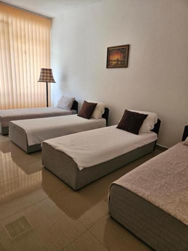 a hotel room with two beds and a couch at Aisham apatment in Košelji