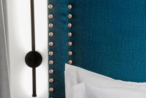 a blue wall with a bunch of buttons on it at Hotel Aptos Alejandra Home by Maxi Hoteles in Granada
