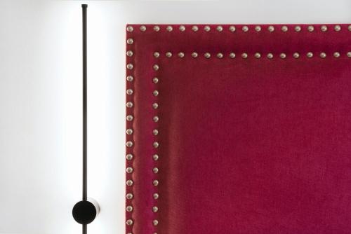 a red cloth with pearl buttons on a wall at Hotel Aptos Alejandra Home by Maxi Hoteles in Granada