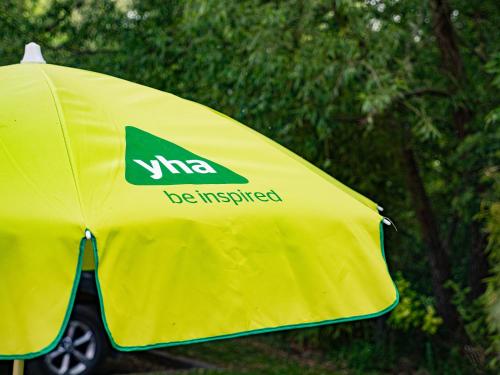 a yellow tent with the words wme be inspired on it at YHA London Lee Valley in Cheshunt