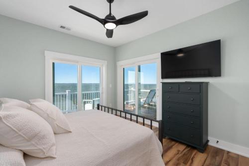 a bedroom with a bed and a flat screen tv at NH599 Nags Head 599 in Nags Head