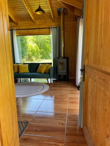 a view of a living room with a couch at Comodidad y Hermosa Vista Volcán in Melipeuco