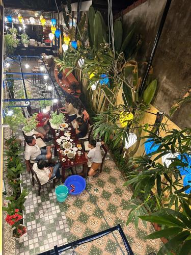 a group of people sitting at tables in a restaurant at Hoi An Old Town Residence - 56 Phan Boi Chau, Hoi An in Hoi An
