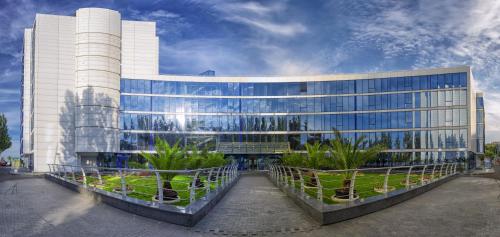 a large building with plants in front of it at Maristella Marine Residence in Odesa