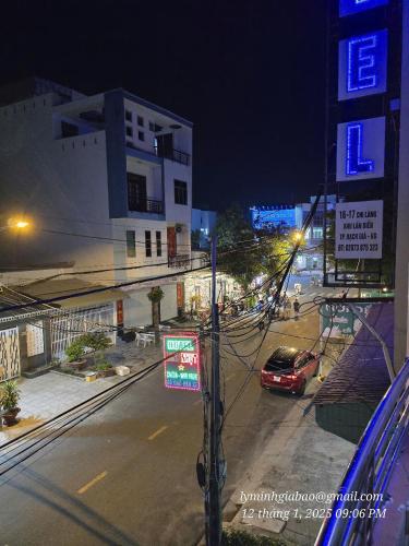 a city street at night with a car parked on the street at Khách Sạn Minh Nhựt in Rach Gia