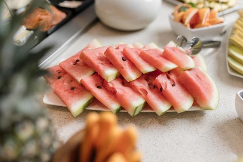 a pile of watermelon slices on a plate on a table at Hotel Bommelje in Domburg