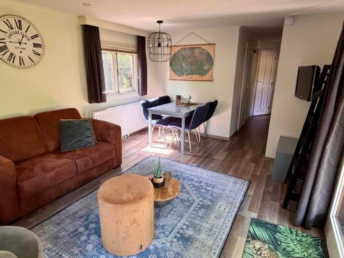 a living room with a couch and a table at Tiny Lodge Basic in Harderwijk