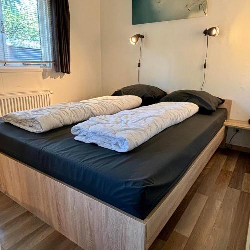 a large bed in a room with two mattresses at Tiny Lodge Basic in Harderwijk