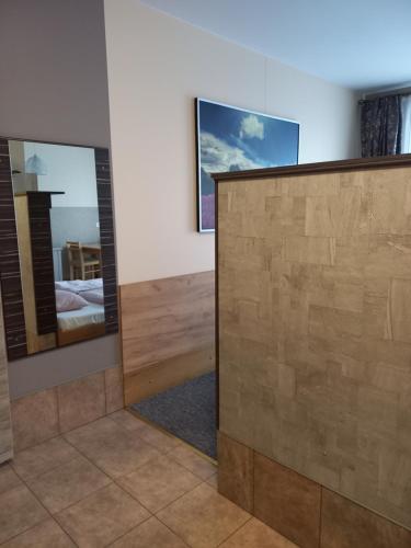 a room with a mirror and a bed in a room at Apartamenty JAGA parking, FVAT in Kielce