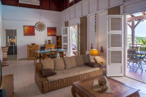 a living room with a couch and a table at TI'BAKOUA in Les Anses-dʼArlets