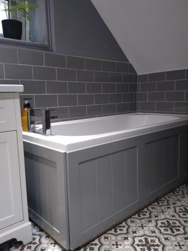 a bathroom with a bath tub and a sink at Peaceful flat in London