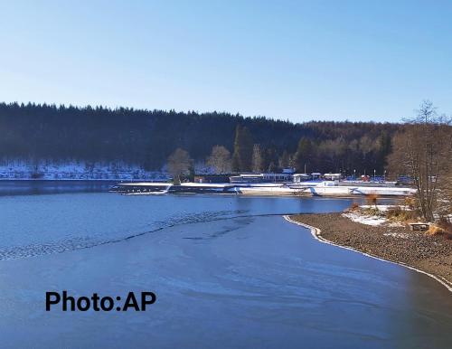 a view of a river with boats in the water at La Tanière du Lac in Robertville