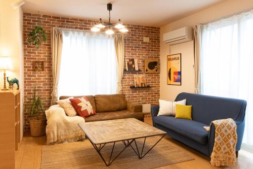 a living room with a couch and a table at Relax Lounge TOKYO in Tokyo