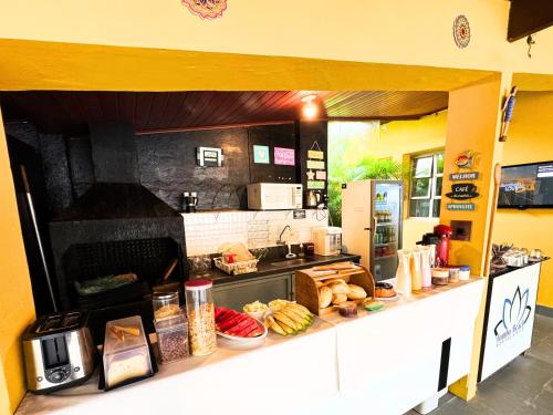 a kitchen with a counter with food on it at Tombo Beach in Guarujá
