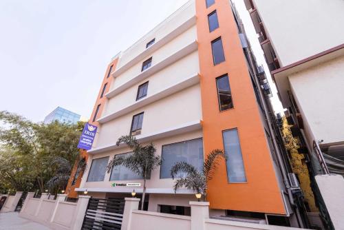 an orange and white building on a street at Treebo Iris Executive, Hinjewadi in Pune