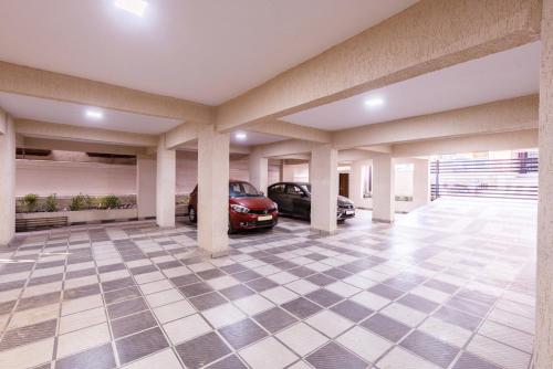 a garage with two cars parked in it at Treebo Iris Executive, Hinjewadi in Pune