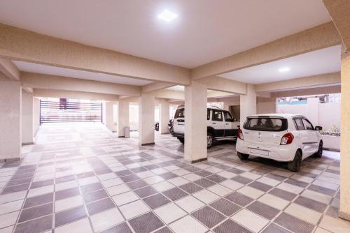 a parking garage with two cars parked in it at Treebo Iris Executive, Hinjewadi in Pune