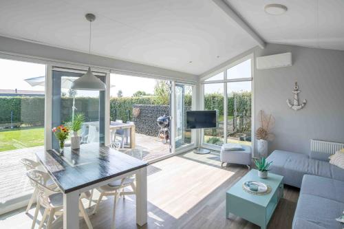 a living room with a table and a couch at Buitenplaats Oudendijke in Ellemeet