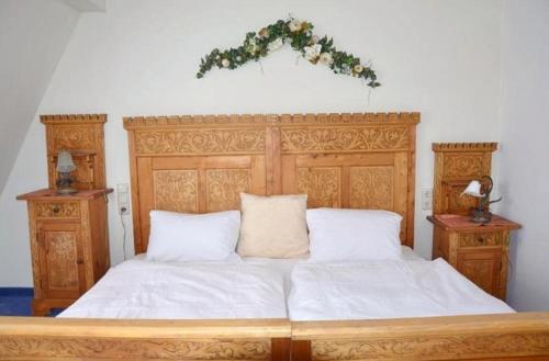 a bedroom with a large wooden bed with areath on it at Apartment Grattschlössl in Sankt Johann in Tirol