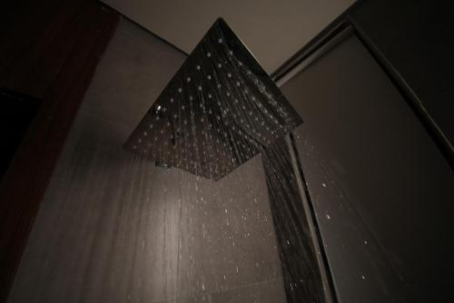 a shower with a shower curtain in a bathroom at Nma a Residences 2 in Riyadh