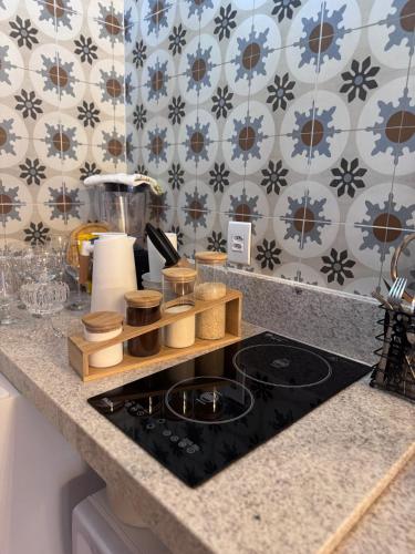 a kitchen counter top with a stove top oven at Pousada Alto Colina - Chalé Quero-quero in Venda Nova do Imigrante