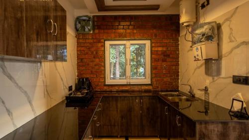 a kitchen with a sink and a window at Secret Garden by The StayCationer in Dehradun