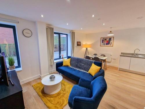 a living room with a blue couch and a table at Free Parking. Old Trafford Home in Manchester
