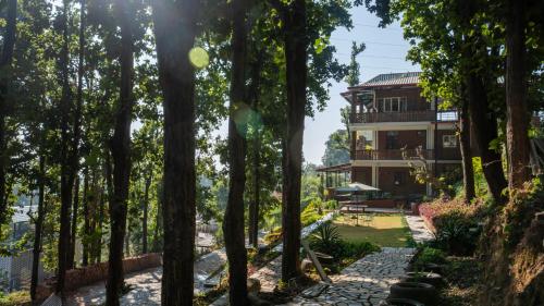a house in the middle of a forest at Secret Garden by The StayCationer in Dehradun