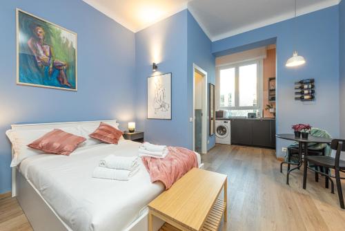 a bedroom with a large bed and a dining room at Canva Suite near Sacco Hospital in Milan