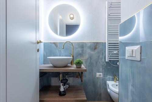 a bathroom with a sink and a mirror at Canva Suite near Sacco Hospital in Milan