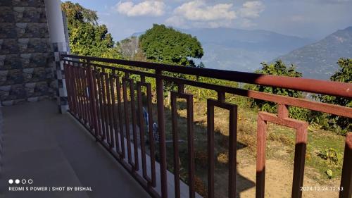 a balcony with a view of the mountains at Namthang Serenity Homestay in Nāmthāng
